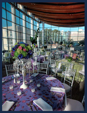 Interior dining table with gorgeous floral centerpieces, a beautiful event held at UC San Diego's Great Hallan outdoor wedding