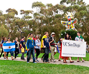 UC San Diego students march with flags of many nations during International Education Week
