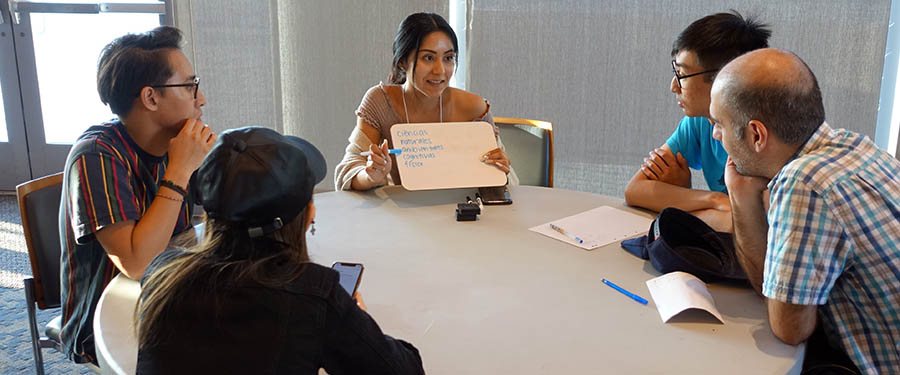 Participants chat around a Language Conversation Table - International House, UC San Diego